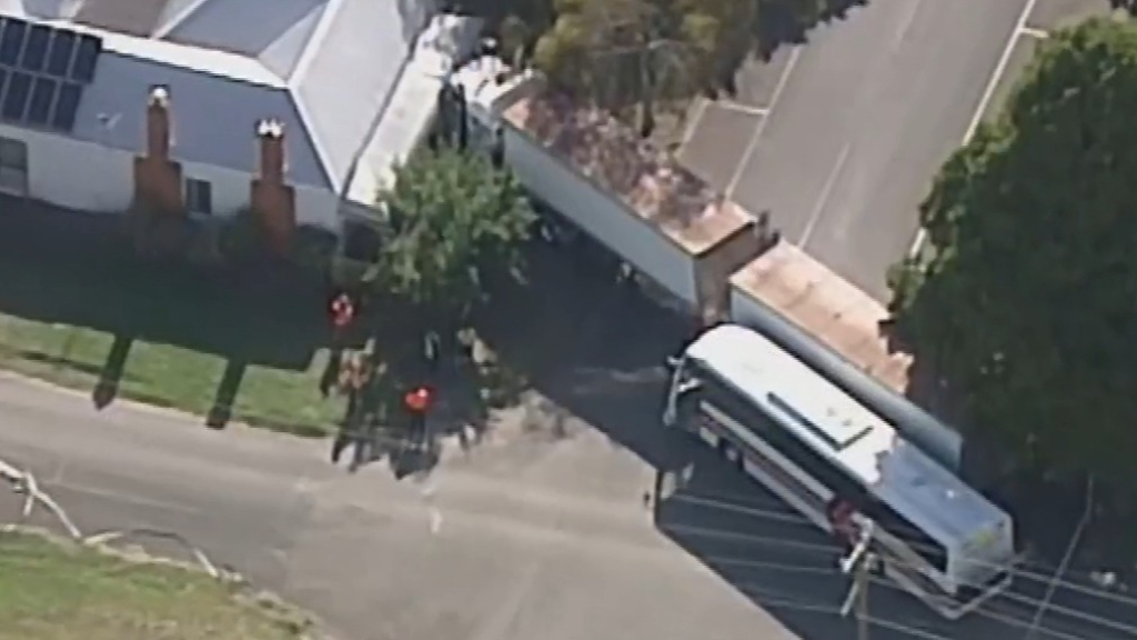 Truck ploughs into house after colliding with school bus in Inverleigh