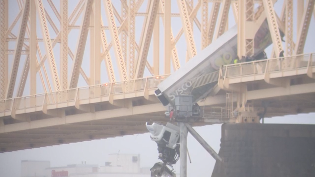 Driver saved as truck dangles over edge of bridge