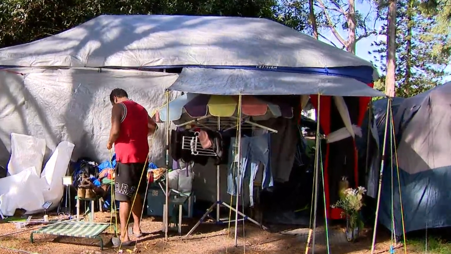 Family of eight sleep in tent while waiting for home
