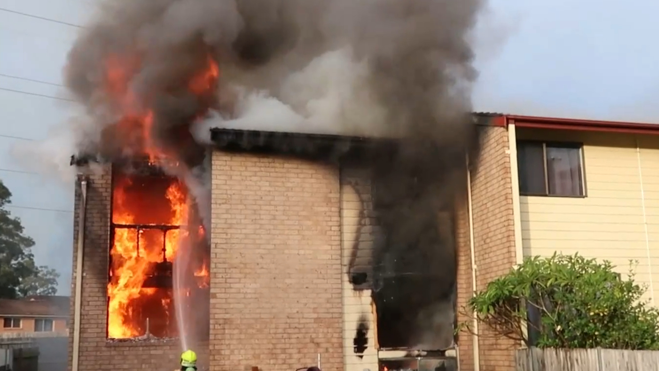 Townhouse gutted by fire after neighbours threated with gun