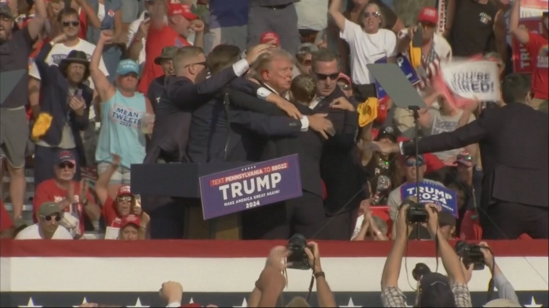 Trump drops to stage floor after alleged gun shots heard at rally