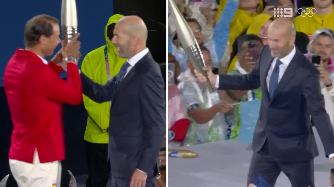 Zinedine Zidane passes the Olympic torch to Rafael Nadal