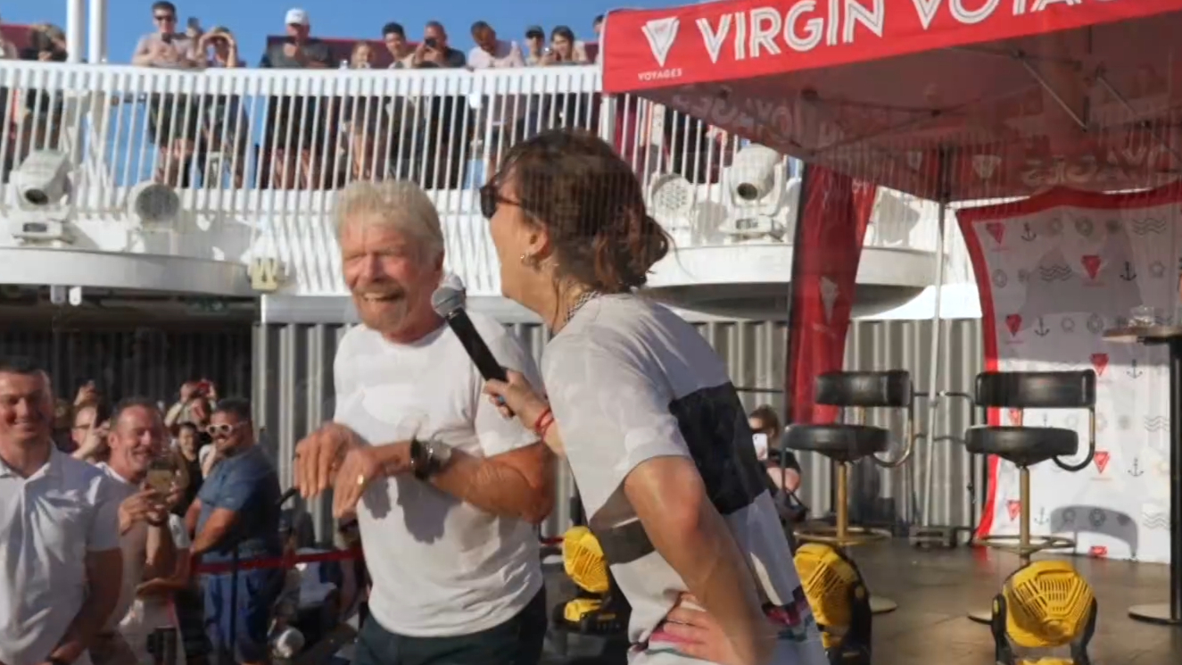 Raygun shows Sir Richard Branson how to breakdance